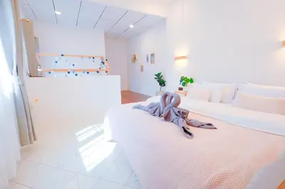 a room with two beds with a towel on them at Ratchada Retreat Villa 2 in Bangkok