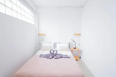 a bedroom with a bed with a purple bow on it at Ratchada Retreat Villa 2 in Bangkok