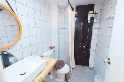 a bathroom with a sink and a toilet and a shower at Ratchada Retreat Villa 2 in Bangkok