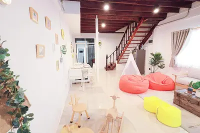 a living room with colorful chairs and a couch at Ratchada Retreat Villa 2 in Bangkok