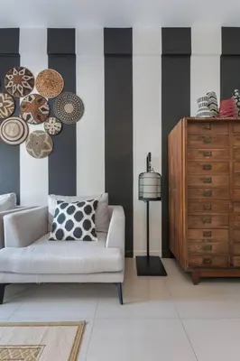 a living room with a white couch and a dresser at Oasis townhouse in the perfect location in Bangkok