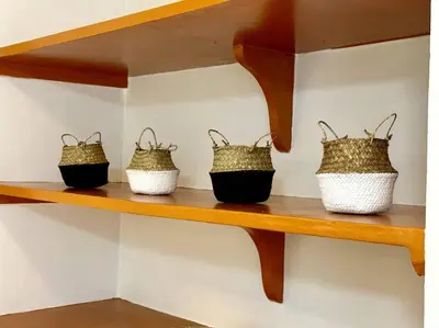 three baskets on a wooden shelf on a wall at Oasis townhouse in the perfect location in Bangkok
