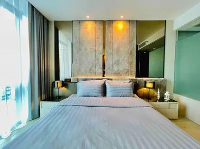 a large bedroom with a large bed with two lamps at Luxurious in Prime Area Bangkok (PickupService) in Bangkok