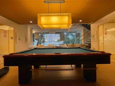 a pool table in a living room with a light at Luxurious in Prime Area Bangkok (PickupService) in Bangkok