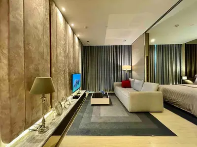 a bedroom with a bed and a couch and a table at Luxurious in Prime Area Bangkok (PickupService) in Bangkok