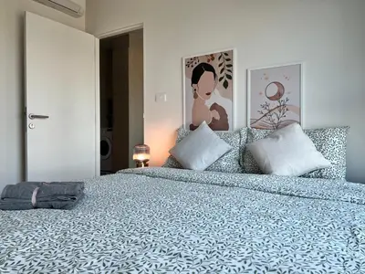 a bedroom with a large bed with blue and white sheets at Ramkhamhaeng Condo in Bangkok