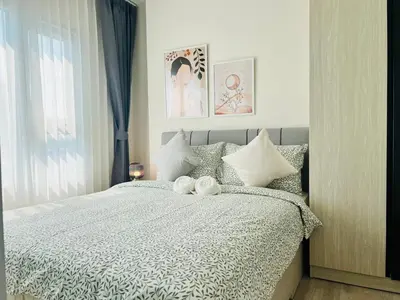 a bedroom with a bed with two towels on it at Ramkhamhaeng Condo in Bangkok