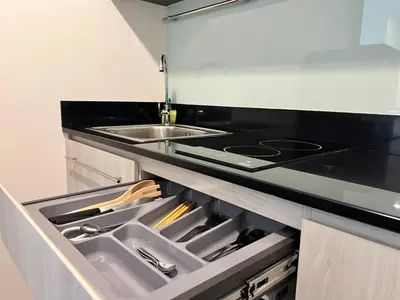 a kitchen with a sink and a stove at Ramkhamhaeng Condo in Bangkok
