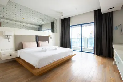 a bedroom with a large bed and a large window at M Estate Private Residence 3BR, Heart of Bangkok in Bangkok