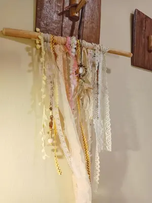a bunch of white crochet hooks hanging on a wall at Be Local BNB in Bangkok
