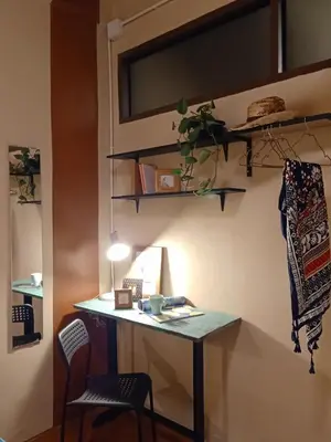 a desk in a room with a table and chairs at Be Local BNB in Bangkok