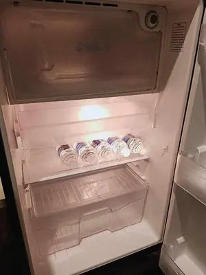 an open refrigerator with food inside of it at Be Local BNB in Bangkok