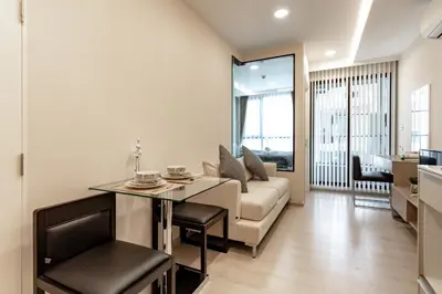a living room with a couch and a table at Bts thonglo 700m free wifi & gym in Ban Hua Khao Sisiat