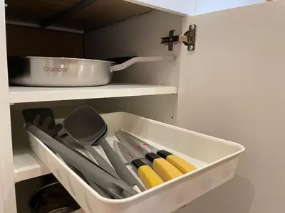 a white drawer filled with utensils in a kitchen at Vélin Khaosan - 2nd Floor apartment with 2Bedrooms in Bangkok