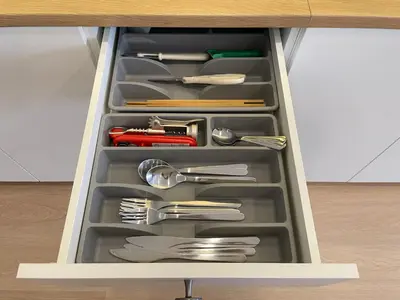 a drawer filled with silver utensils in a cabinet at Vélin Khaosan - 2nd Floor apartment with 2Bedrooms in Bangkok