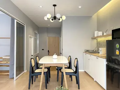 a kitchen with a dining room table and chairs at Vélin Khaosan - 2nd Floor apartment with 2Bedrooms in Bangkok