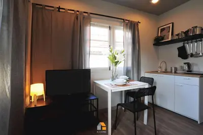 a kitchen with a table with a television and a table with chairs at Arasa House by G Living -6mins MRT Klong Bang Phai in Ban Khung Taphao