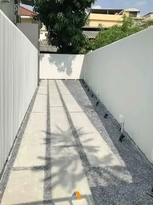 a sidewalk next to a white fence next to a building at Arasa House by G Living -6mins MRT Klong Bang Phai in Ban Khung Taphao