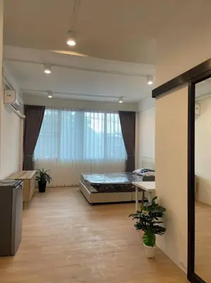 a large room with a bed and a window at 33 Avenue in Bangkok
