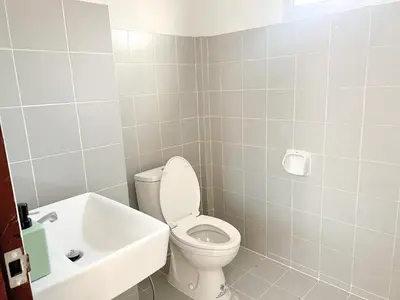 a bathroom with a toilet and a sink at Jaruchok Apartment in Bangkok