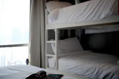 two bunk beds in a room with a window at Sukhumvit Boutique Suite : Soi 13/ 10min. from BTS Nana station in Bangkok