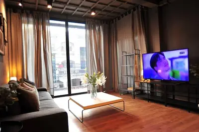 a living room with a flat screen tv and a couch at STAY-DIUM House Huamark in Ban Bang Toei (1)