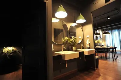 a bathroom with two sinks and two mirrors at STAY-DIUM House Huamark in Ban Bang Toei (1)