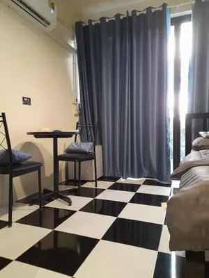 a bedroom with a black and white checkered floor at Noir Cafe And Hostel Chinatown Bangkok in Chinatown