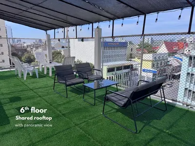 a group of chairs and a table on a balcony at Vélin Khaosan - 3rd Floor apartment with 2Bedrooms in Bangkok