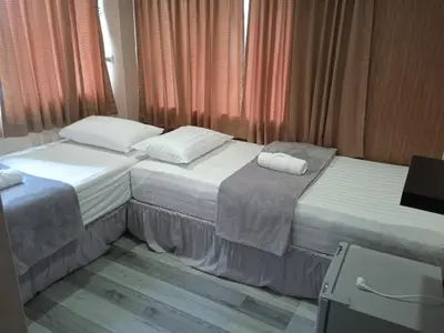 two beds sitting next to each other in a room at KS HOUSE in Bangkok