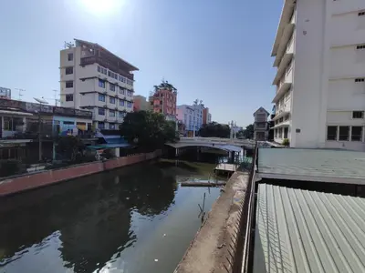 a river in the middle of a city with buildings at KS HOUSE in Bangkok