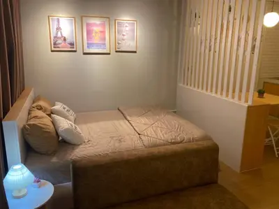 a small bed in a small room with pictures on the wall at PTJ Style Condotel คอนโดเมืองทอง in Ban Bang Phang