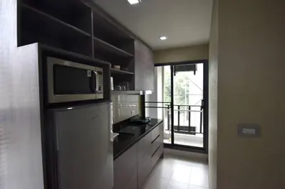 a kitchen with a refrigerator and a microwave at BTS 46 - Near BTS Phrakhanong in Bangkok