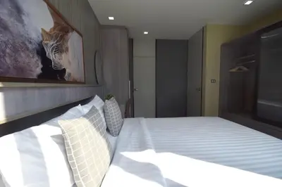 a bedroom with a bed with a painting of a zebra at BTS 46 - Near BTS Phrakhanong in Bangkok
