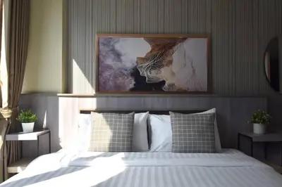a bedroom with a bed with a picture of a tiger at BTS 46 - Near BTS Phrakhanong in Bangkok