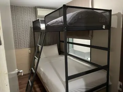 two bunk beds in a small room with a bed at BTS 46 - Near BTS Phrakhanong in Bangkok