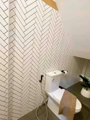 a bathroom with a white toilet in a room at Relax in town,Grand Palace in Bangkok
