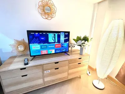 a living room with a flat screen tv on a dresser at Relax in town,Grand Palace in Bangkok