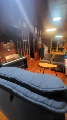 a room with a bed and a table and chairs at Aran Cottage Ngamwongwan The Pool Villa in japanese Garden in Nonthaburi