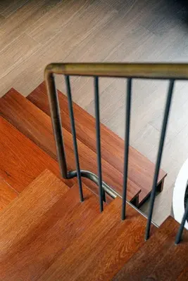 a metal rail on the bottom of some stairs at Na Tanao 1969 in Bangkok