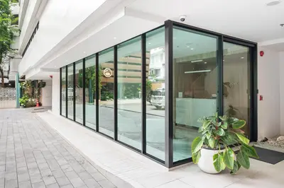 a large group of glass doors on a building at LiveZen Bangkok Sukhumvit in Khlong Toei