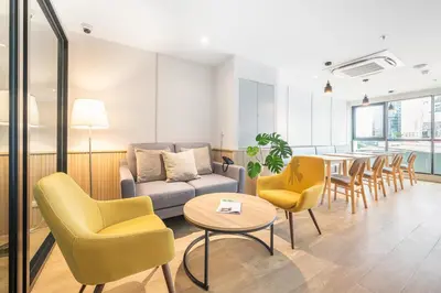 a living room with a couch and chairs and a table at LiveZen Bangkok Sukhumvit in Khlong Toei