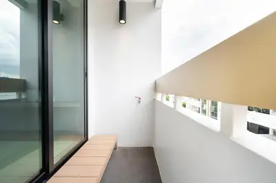 a hallway of a house with white walls and windows at LiveZen Bangkok Sukhumvit in Khlong Toei