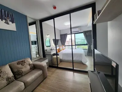a bedroom with a bed and a couch in a room at ABoutNont HOTEL & MANSION in Nonthaburi