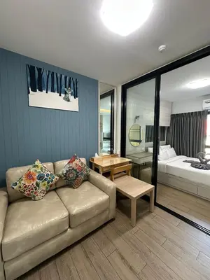 a living room with a couch and a table at ABoutNont HOTEL & MANSION in Nonthaburi