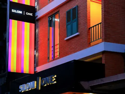 a building with colorful stripes on the side of it at Silom One in Bangkok