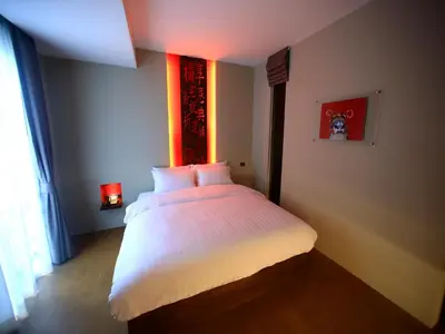 a bedroom with a large white bed in a room at Silom One in Bangkok