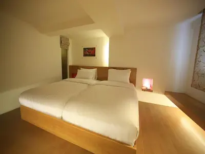 a bedroom with a large white bed in a room at Silom One in Bangkok
