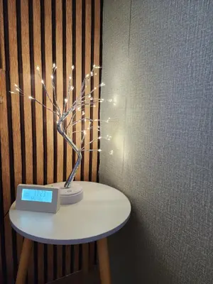a table with a tree with lights on it at 205-Olan Place Homely room Free Wi-Fi and Near BTS line in Ban Yang