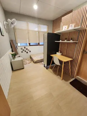 a room with a desk and a table in it at 205-Olan Place Homely room Free Wi-Fi and Near BTS line in Ban Yang